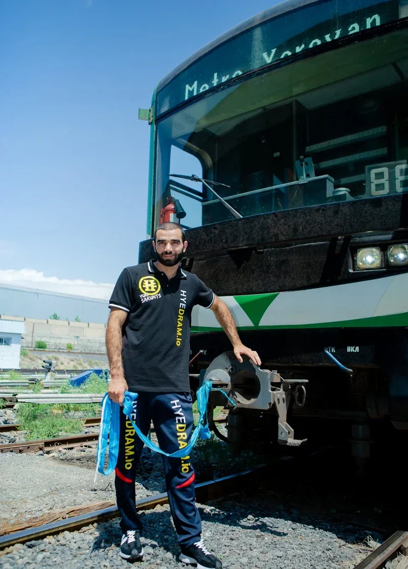 Yuri Sakunts — Athlete beside rail vehicle